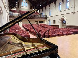 Elder Hall interior showing new seats looking back from the stage through an open grand piano