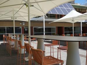 Hub eastern courtyard with high tables, umbrellas and chairs