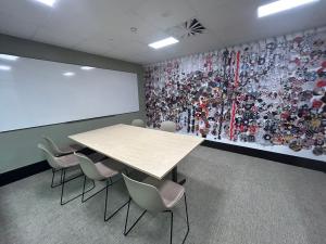 Hub level 3 project room with table, chairs and artwork