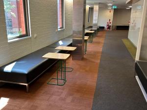 Hub level 3 corridor with bench seating and small tables