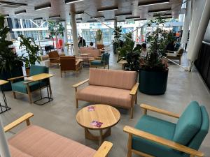 Hub level 4 lounge with plush couch, tables and planter boxes