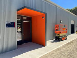 EXTERRES facility front of building with orange door
