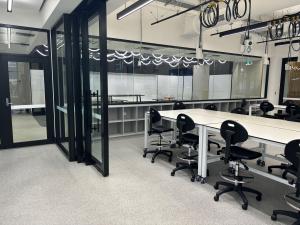 Engineering South teaching laboratory looking towards the breakout area showing glass partitions and loose forniture