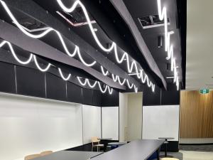 Engineering South break out space with curly lights, high and low tables