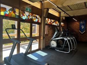 Close up of Fitness Hub workout room with equipment overlooking stained glass windows