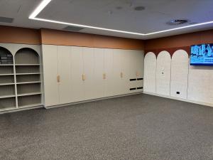 Empty Fitness Hub yoga studio with shelves