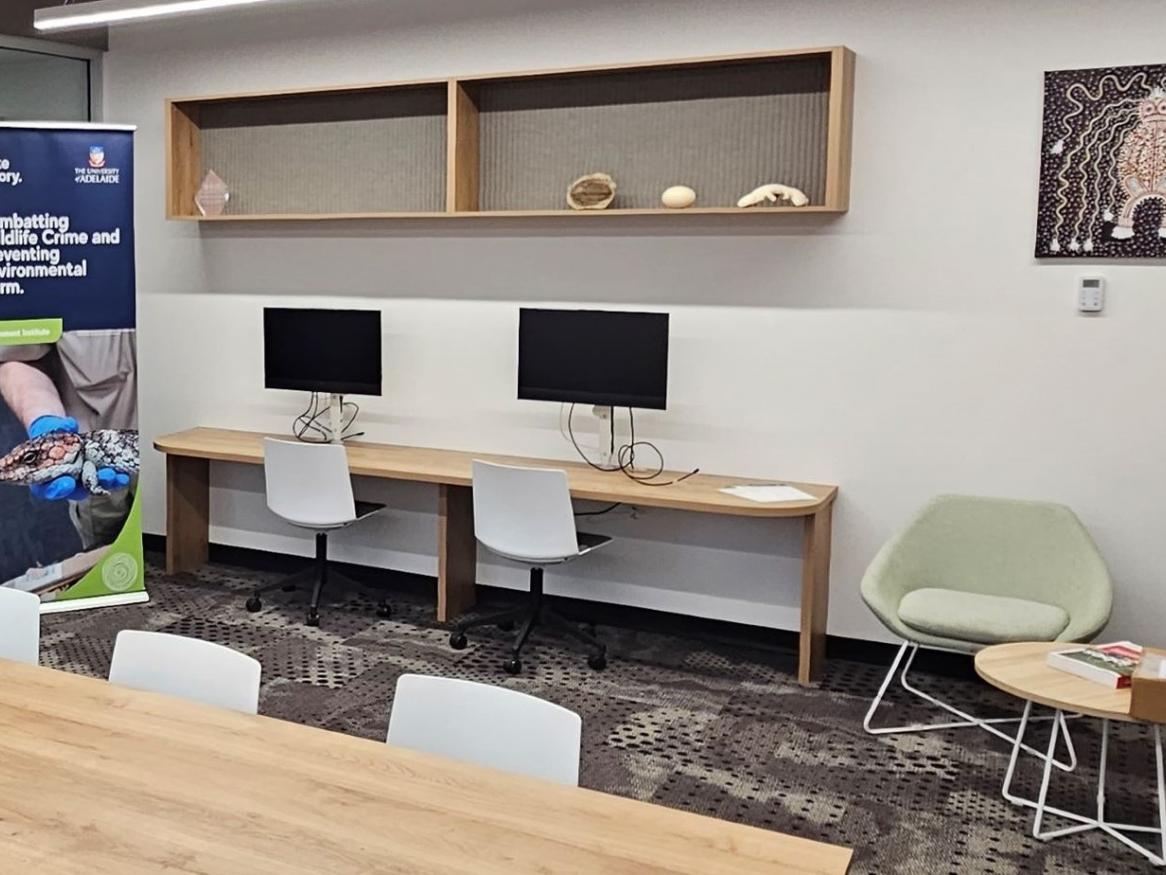 Meeting room with boardroom table, chairs and banner