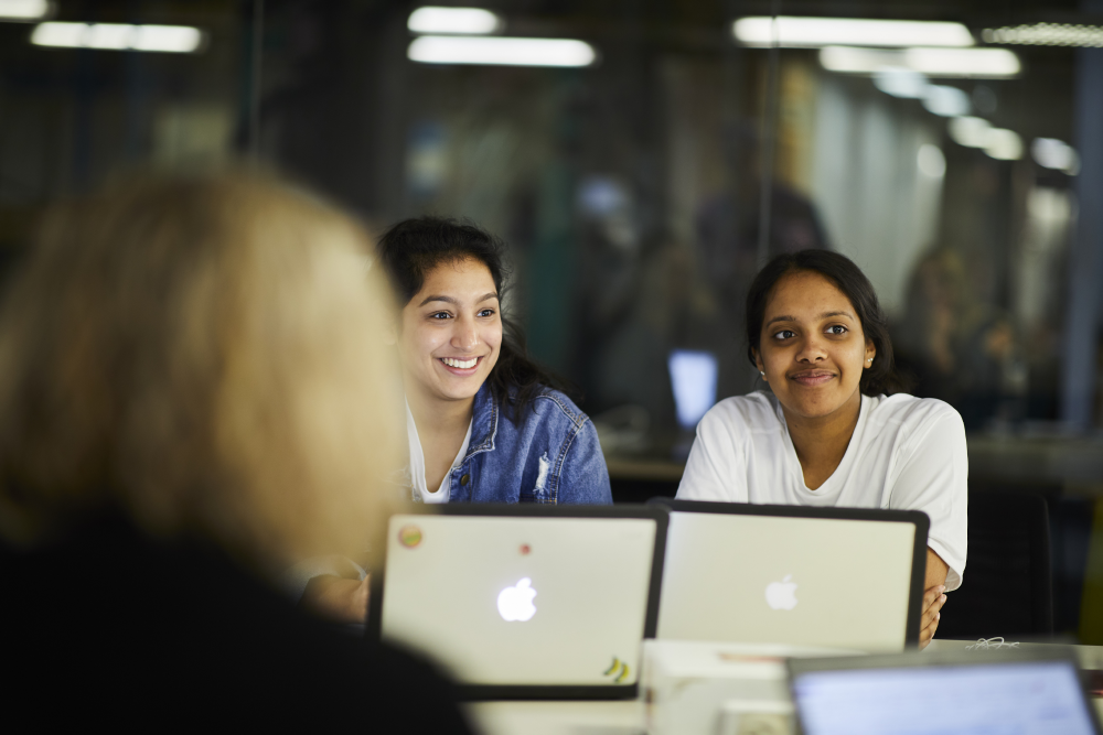 Students smiling on computers