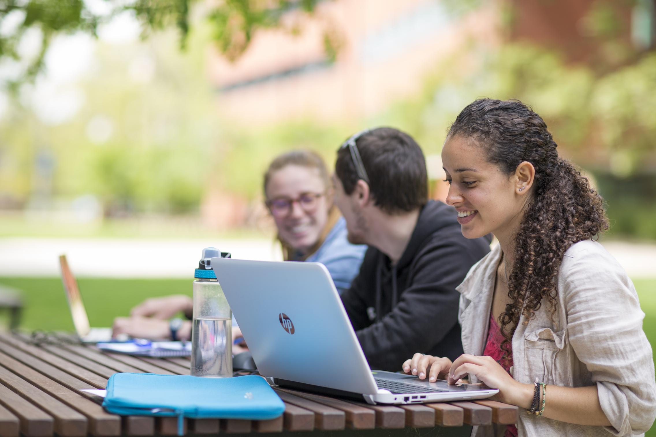 Students studying outside on lovely spring day