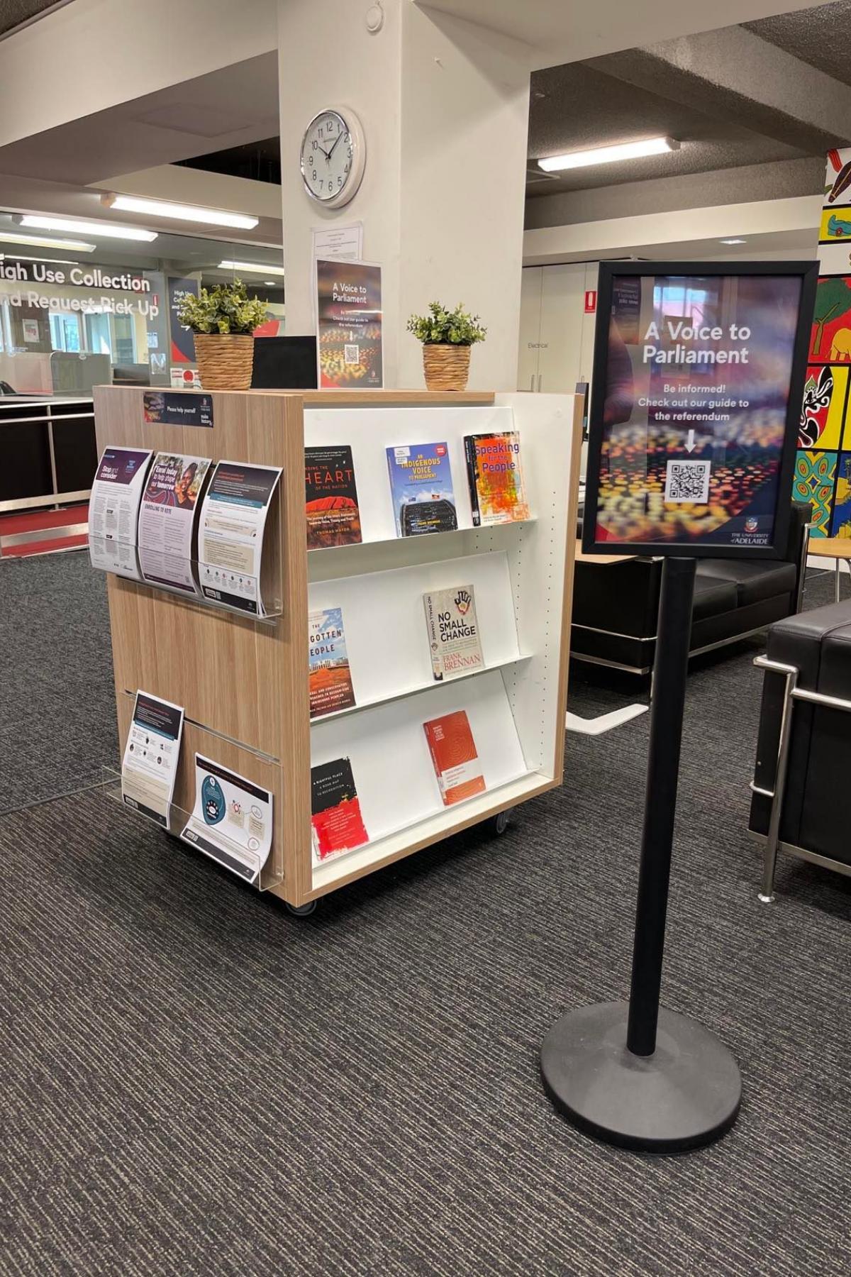 A book display with leaflets on one side
