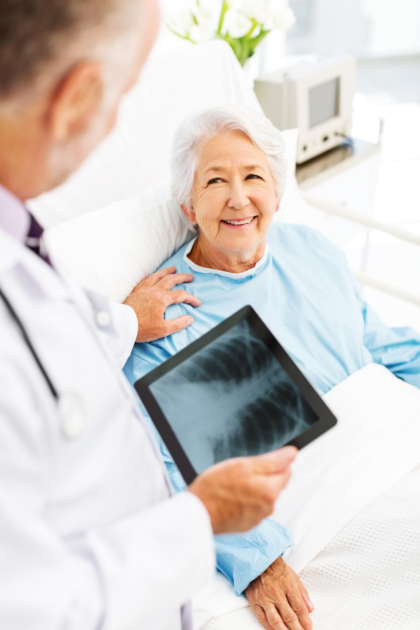 Elderly patient discussing x-ray with doctor