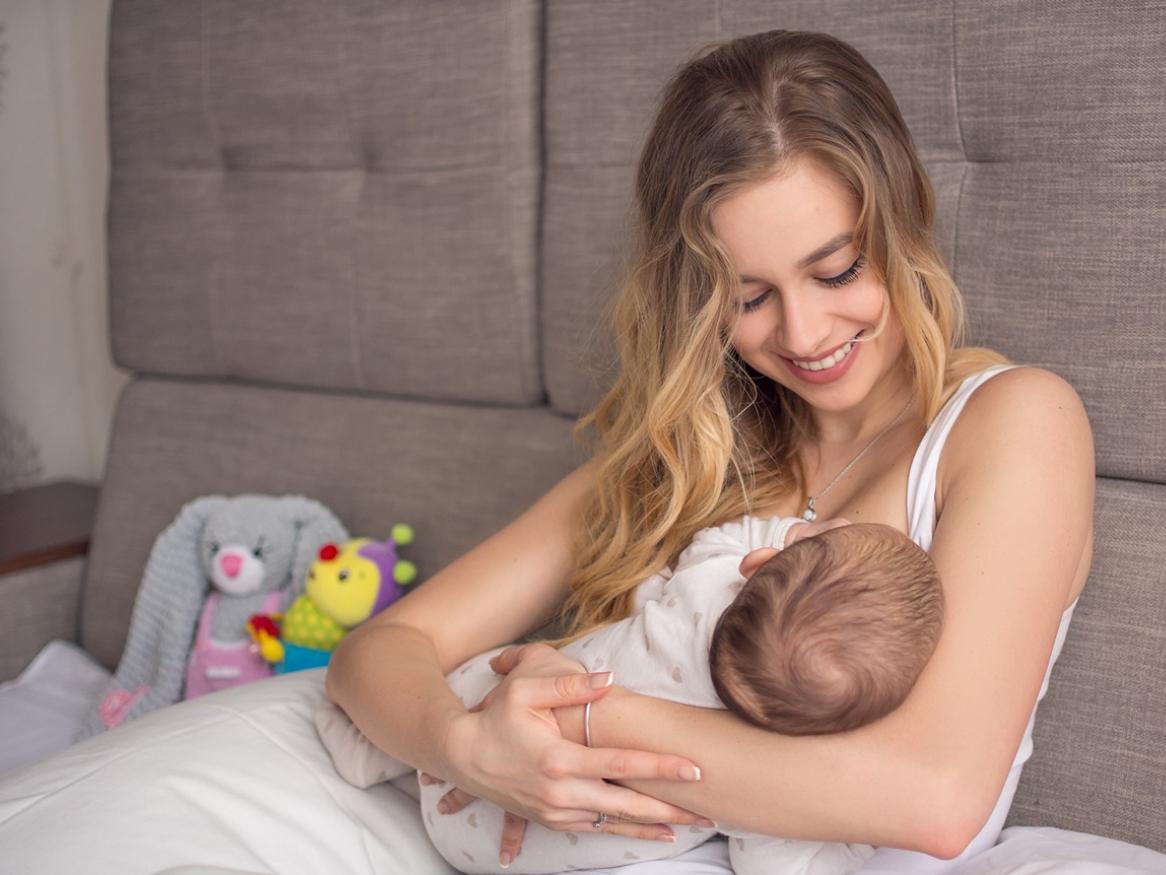 A woman breastfeeding an infant