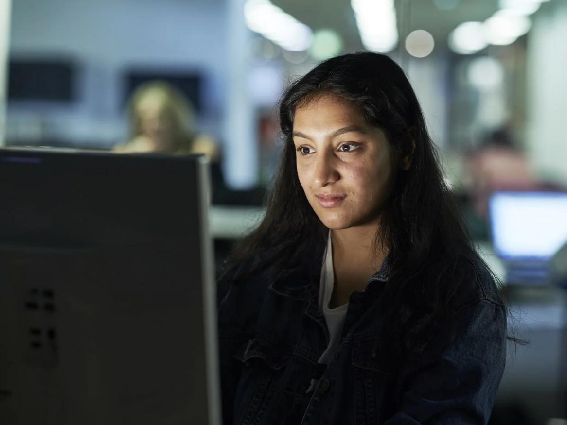 A woman looking at a computer