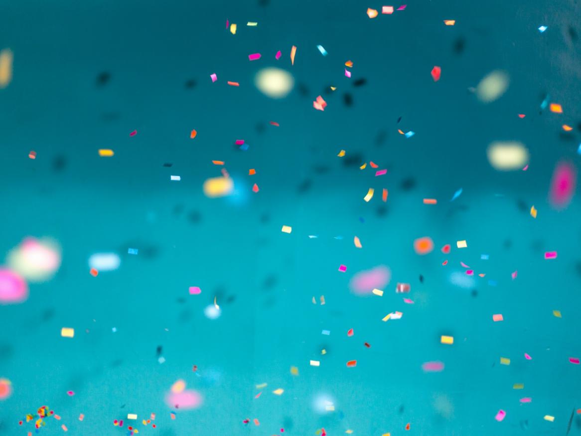 Confetti falling against blue background