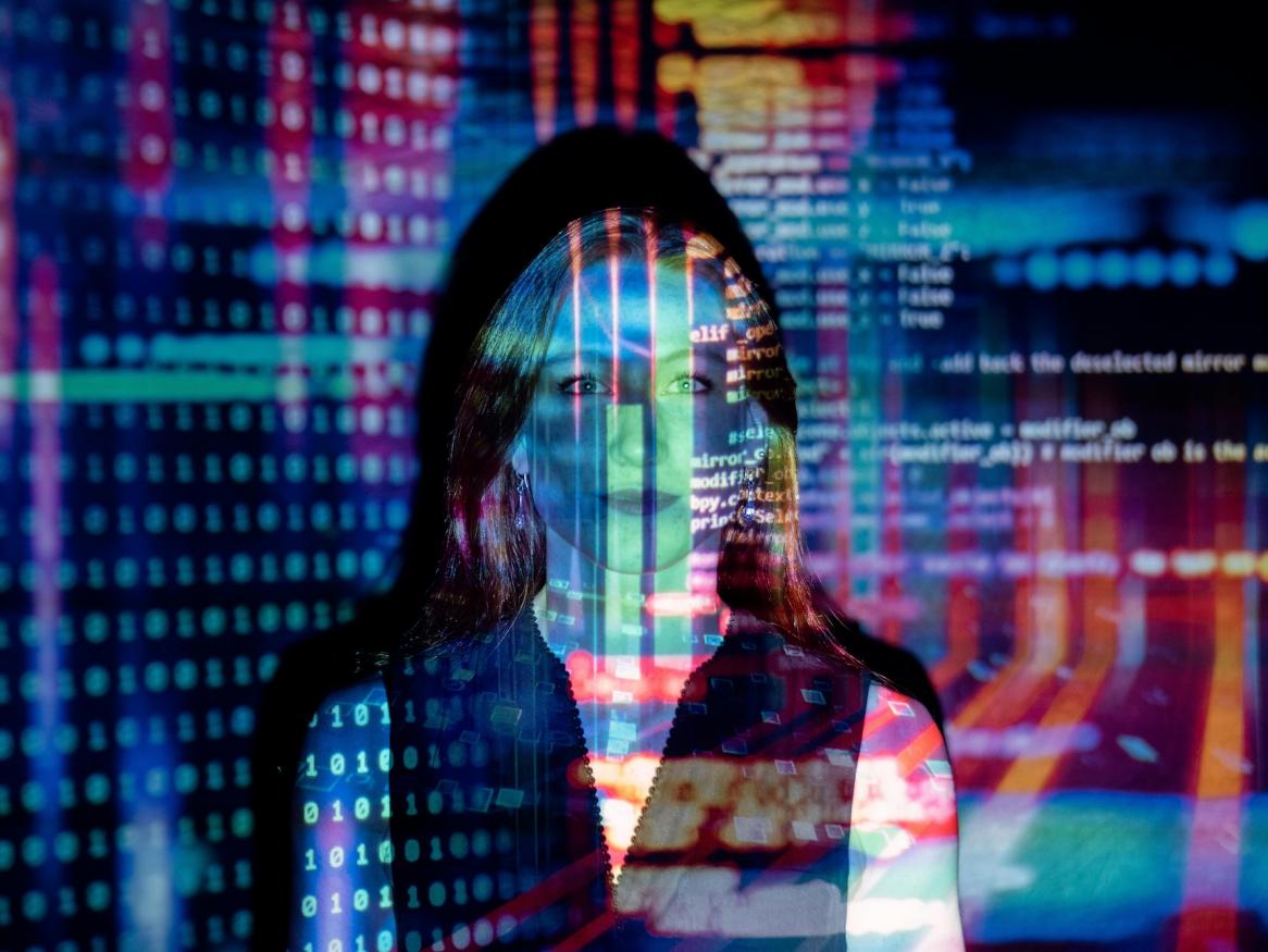 Woman with coding projected over the top. 