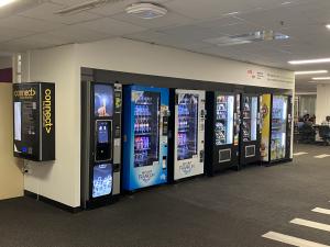 Photo of CONNECT machine attached to wall on corner near vending machines, Hub Central Level 3