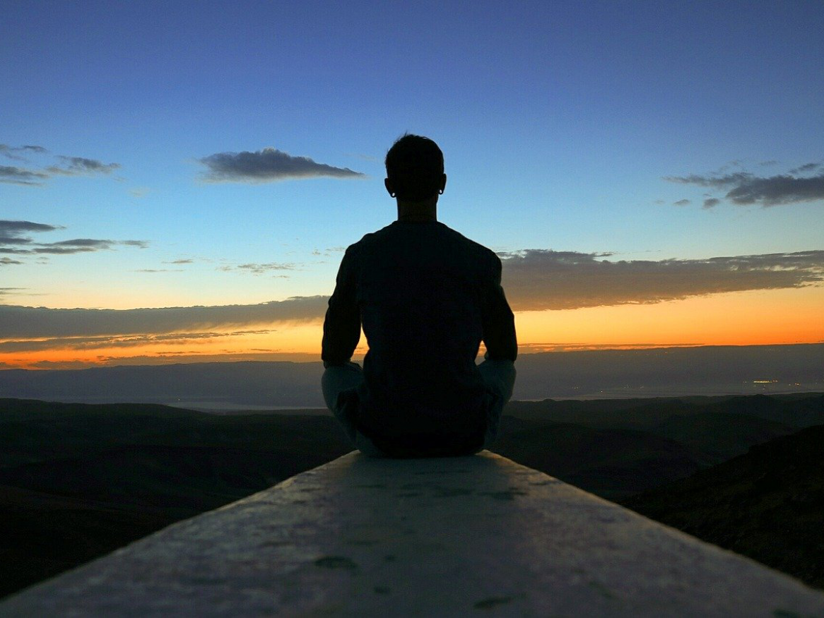 man meditating at dawn - image 