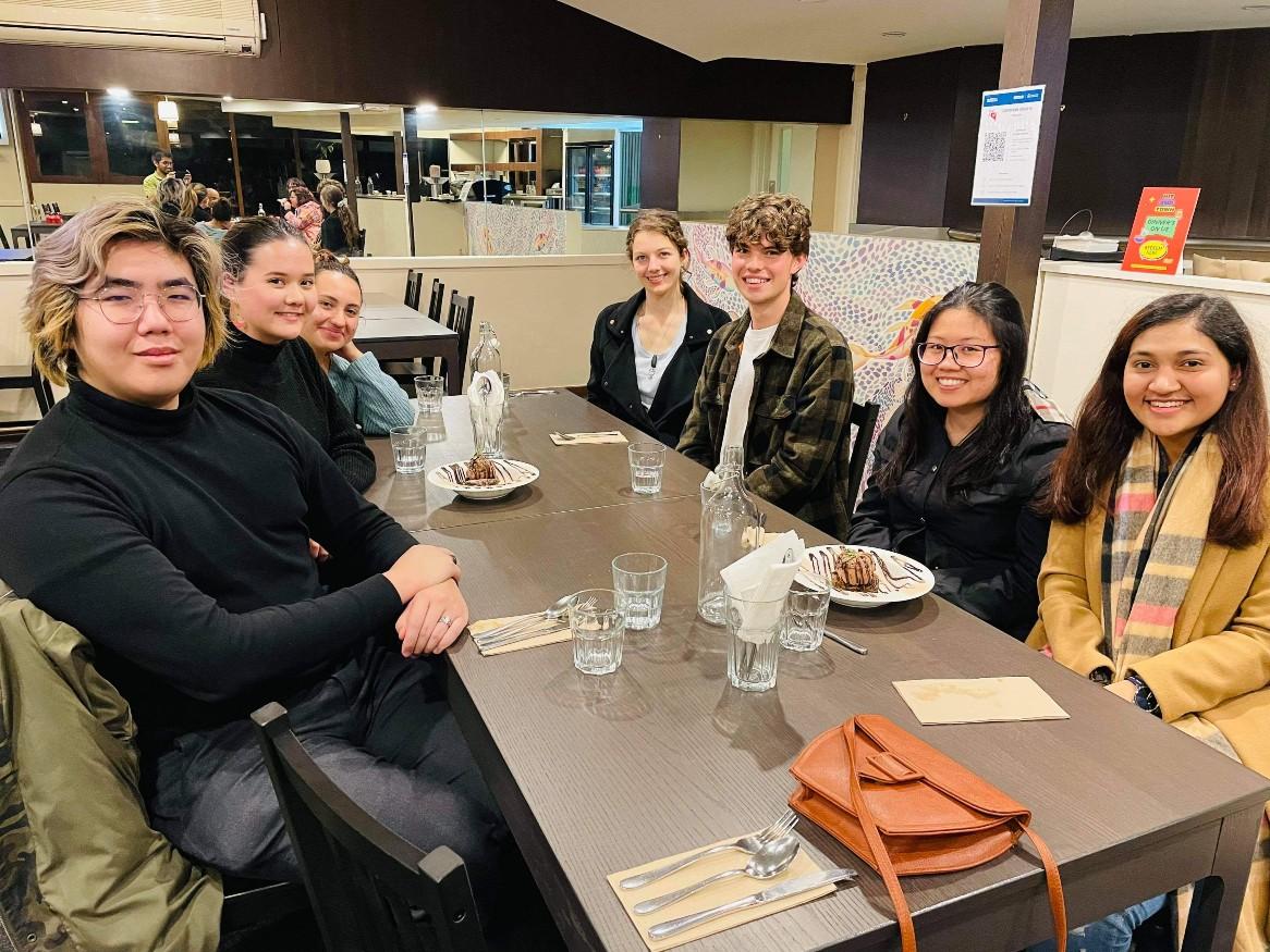 Group of friends sitting at table in restaurant