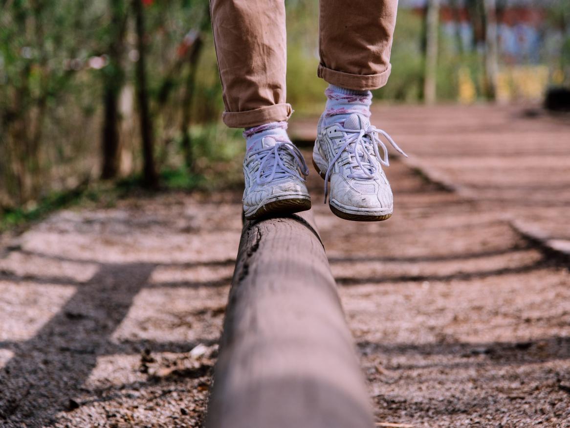 Person balancing on a log