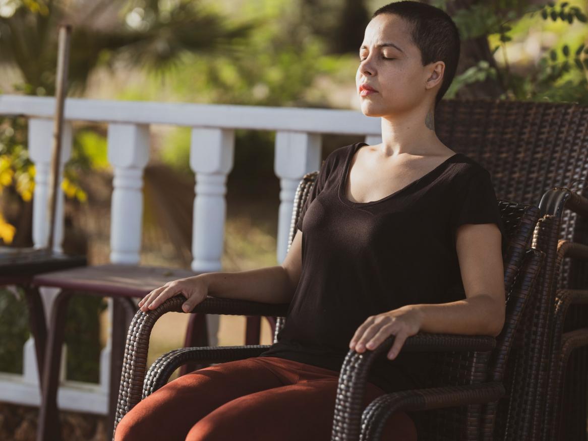 Women meditating in a chair