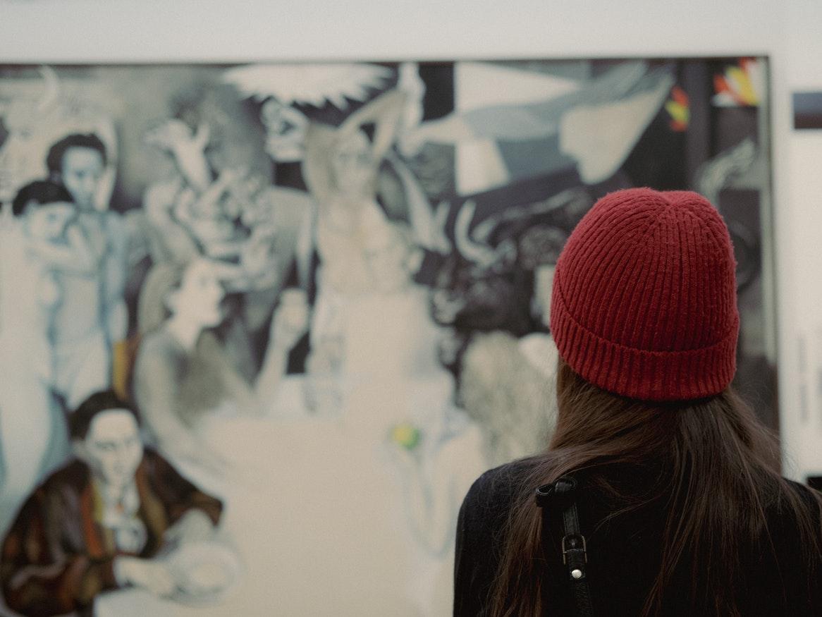 Woman standing in front of a painting