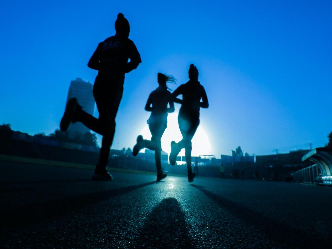 Silhouette of people running.