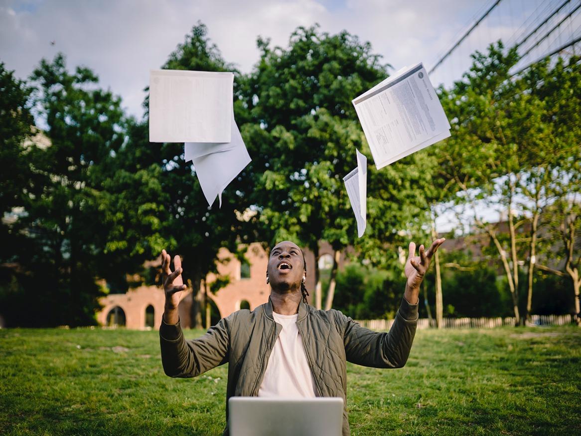 A man throwing the exam paper