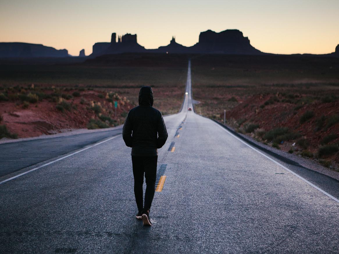 person walks on country road 