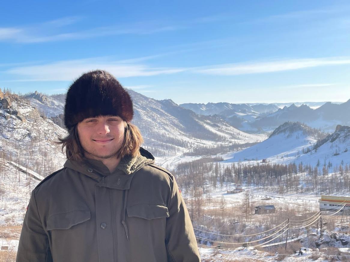 Piero in front of snowy mountains in Mongolia (2023).