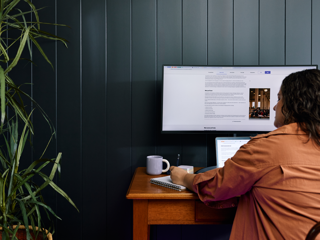 student on a couch with laptop